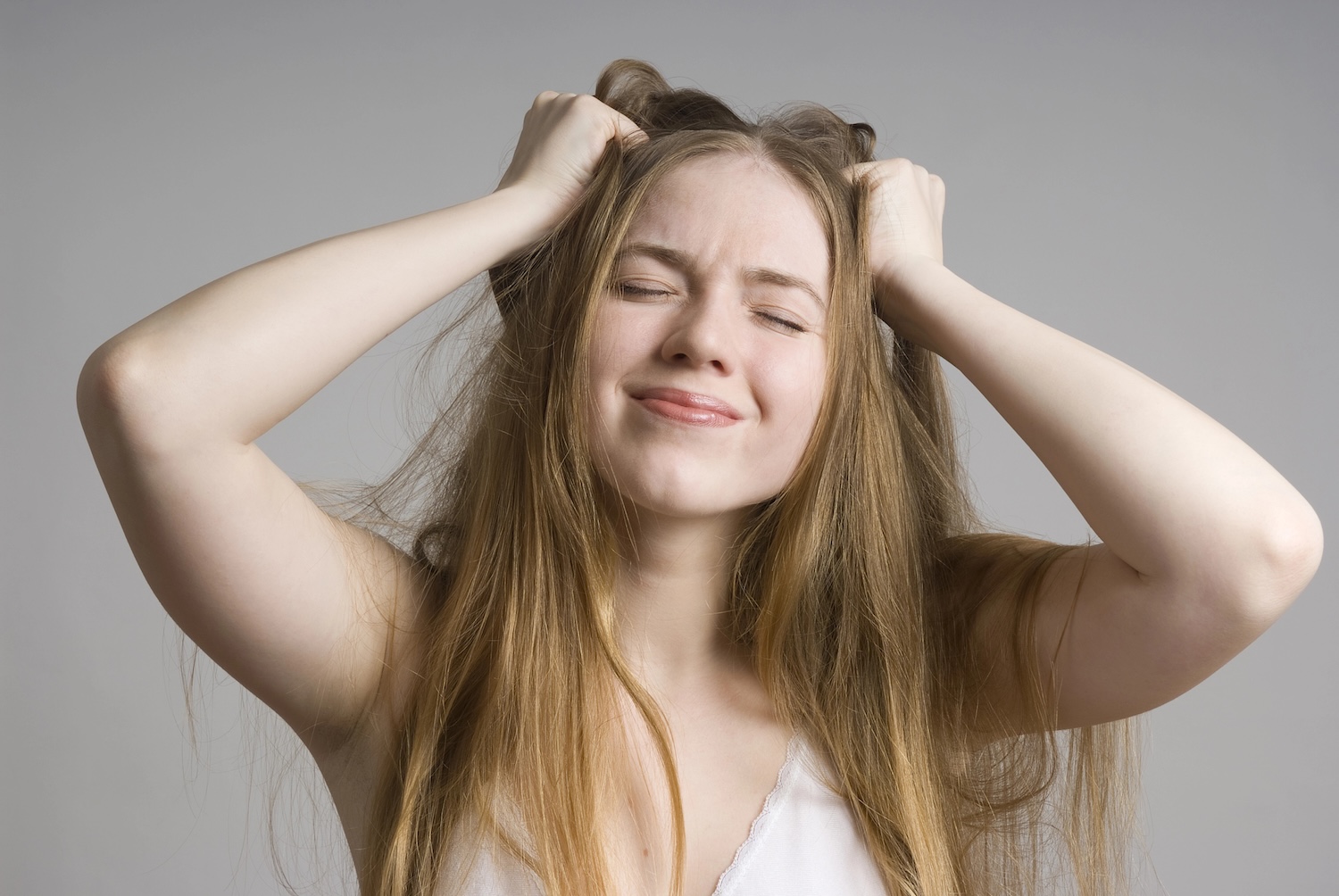 A worried mother with her hands in her hair