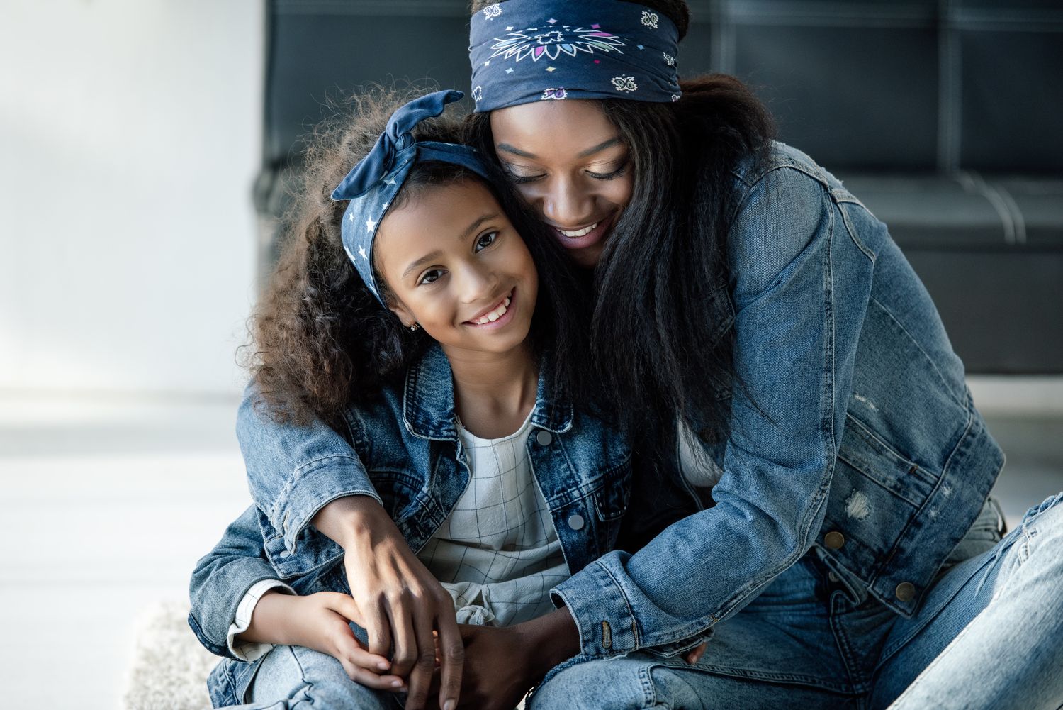 A smiling girl and woman embracing