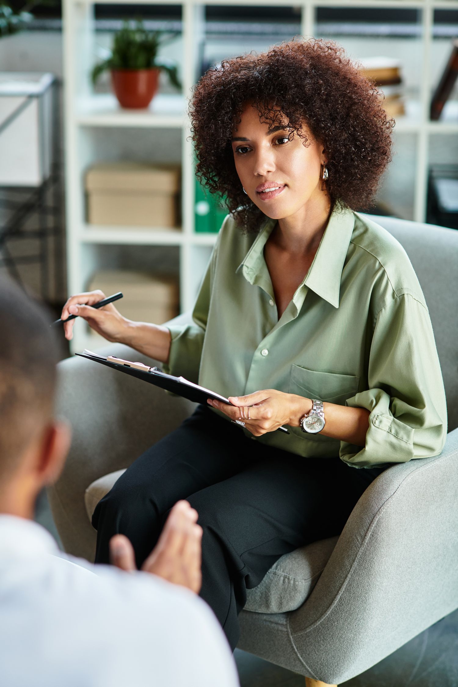 A therapist listening to a client during a session